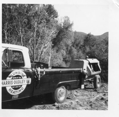 B&W photo of an old Harris Dudley truck with trailer
