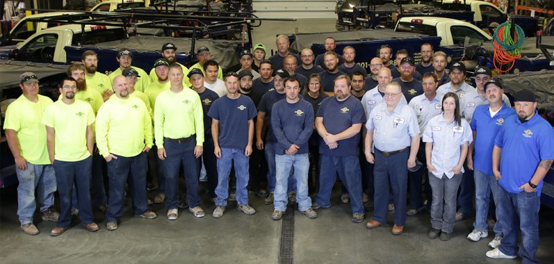 Group shot of the employees of Harris Dudley inside thier building